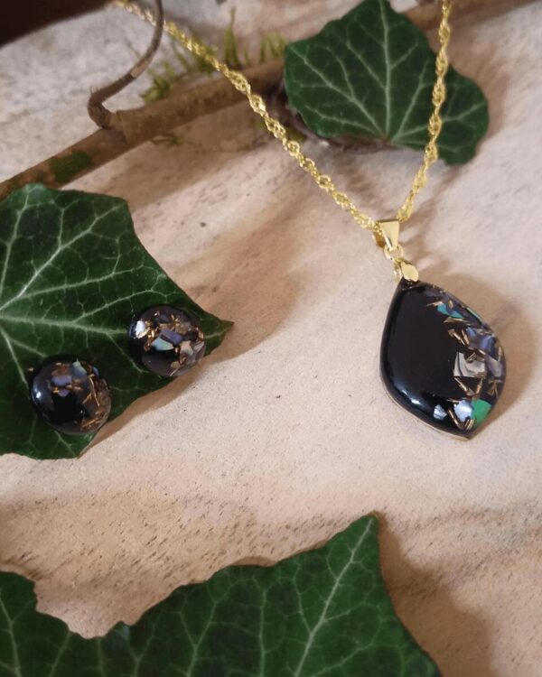 Parure fabriquée à la main en nacre violette et éclat de laiton. Cet assortiment ajoute une touche de mystère et attire le regard.